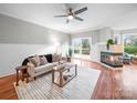 Cozy living room with hardwood floors, fireplace, ceiling fan, and sliding doors to outdoor deck at 209 Chesterfield Canal None, Fort Mill, SC 29708