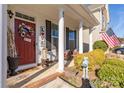 Cozy front porch adorned with decorative wreath and American flag at 223 Blossom Ridge Dr # 137, Mooresville, NC 28117