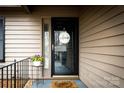 Inviting front entrance with a decorative 'welcome' wreath and flower decor at 2710 Redbud Ln, Fort Mill, SC 29715