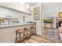 Bright, open kitchen and bar area leading to a cozy living room with hardwood floors and neutral paint at 2710 Redbud Ln, Fort Mill, SC 29715