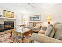 Warm and inviting living room with a stone fireplace, plush furniture, and natural light at 2710 Redbud Ln, Fort Mill, SC 29715