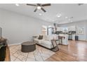 Bright living space with hardwood floors, ceiling fan, and an open layout to the kitchen at 309 Lloyd St, Salisbury, NC 28144