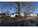 Row of houses, gray house with red brick, tree-lined street at 315 S Hill St, Gastonia, NC 28052