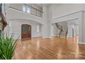 Open foyer with a two-story ceiling, wood front door, and staircase at 4008 Quintessa Dr, Matthews, NC 28104