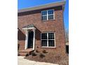 Two-story brick townhouse with white trim and a black door at 451 Beacon Nw St # 6, Concord, NC 28027