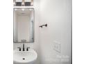 Modern half bathroom featuring a vessel sink, black hardware, and minimalist design at 4605 Western Union School Rd, Waxhaw, NC 28173