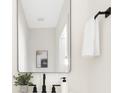 Clean bathroom with a modern mirror, sleek black hardware, and a white sink at 4605 Western Union School Rd, Waxhaw, NC 28173
