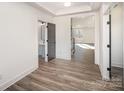 Bright entryway with a gray accent door to the bathroom and wood-look flooring at 4605 Western Union School Rd, Waxhaw, NC 28173