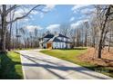 Sweeping view of home with long driveway, lush lawn and mature trees at 4605 Western Union School Rd, Waxhaw, NC 28173