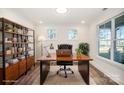 Cozy home office with a large wooden desk, shelving, and natural light from two windows at 4605 Western Union School Rd, Waxhaw, NC 28173