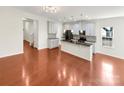 Open concept kitchen with an island, hardwood floors, and white cabinets at 4903 Greenloch Ct, Monroe, NC 28110