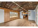 Living room with hardwood floors and rustic tin ceiling at 499 Indian Hill Rd, Olin, NC 28660