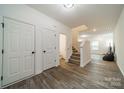 Bright entryway with stairs, powder room, and wood-look flooring at 518 Switch St, York, SC 29745