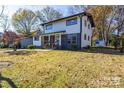 Two-story house with a spacious yard and shed visible in the background at 6309 Spring Garden Ln, Charlotte, NC 28213