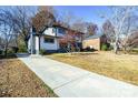 Two-story house with driveway, front yard, and neighboring houses visible at 6309 Spring Garden Ln, Charlotte, NC 28213