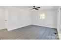 Bright living room with gray vinyl flooring and ceiling fan at 6309 Spring Garden Ln, Charlotte, NC 28213