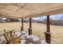 Covered porch with brick pillars and wooden bench at 643 Alf Hoover Rd, Lincolnton, NC 28092