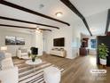 Spacious living room featuring exposed beams and a modern aesthetic at 7015 Cardigan Ave, Charlotte, NC 28215