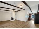 Open concept living room with hardwood floors and fireplace at 7015 Cardigan Ave, Charlotte, NC 28215