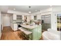 Bright kitchen featuring stainless steel appliances, an island with a granite countertop, and hardwood floors at 821 Greentree Dr, Charlotte, NC 28211