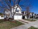 View of home showcasing garage, landscaping, and neighbor's homes at 9613 Long Hill Dr, Charlotte, NC 28214