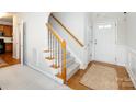 Hallway with staircase, wooden floors, and neutral decor at 9613 Long Hill Dr, Charlotte, NC 28214