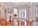 Elegant foyer with gleaming hardwood floors and a glimpse of the office space at 102 W Vista View Pl, Mooresville, NC 28117