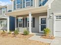 Inviting front porch with classic columns and a view of the home's entrance at 1036 Barnette Farm Ln, Monroe, NC 28110