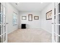 Well-lit carpeted office with french doors and ample natural light at 1036 Barnette Farm Ln, Monroe, NC 28110