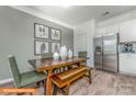 Kitchen dining area with wooden table, bench, and green chairs at 1129 Red River Dr, Salisbury, NC 28144