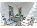 Small patio with four chairs and a table, featuring potted succulents at 1129 Red River Dr, Salisbury, NC 28144