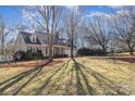 One story home with a double car garage, long driveway and mature trees at 11918 Parks Farm Ln, Charlotte, NC 28277