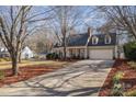 One story home with a double car garage, long driveway and mature trees at 11918 Parks Farm Ln, Charlotte, NC 28277