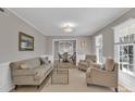 Bright living room featuring hardwood floors, neutral paint, and abundant natural light at 12325 Parks Farm Ln, Charlotte, NC 28277