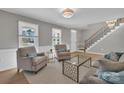 Cozy living room with hardwood floors, neutral paint, and a staircase leading to the upper level at 12325 Parks Farm Ln, Charlotte, NC 28277