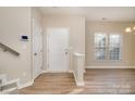 Bright living room features wood-style flooring and a front door that brings in natural light at 12584 Jessica Pl, Charlotte, NC 28269