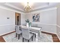 Elegant dining room with a chandelier, crown molding, and a view into the adjacent kitchen at 12907 Mccahan Ln, Huntersville, NC 28078