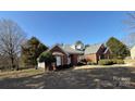 Attractive brick house featuring a well-maintained lawn, bay windows and professional landscaping in a neighborhood setting at 13501 Misty Dew Ct # 19, Charlotte, NC 28273