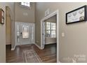 Grand foyer with a soaring ceiling, hardwood floors, and elegant double doors creating a stunning first impression at 1412 Great Rd, Waxhaw, NC 28174