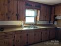 Simple kitchen with wood cabinets and double sink at 1674 Fallston Rd, Shelby, NC 28150