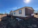 Side view of the mobile home showing damage at 169 Adams Cir, Candor, NC 27229