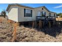 View of the mobile home's side and deck at 169 Adams Cir, Candor, NC 27229