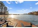 Inviting dock view complete with Adirondack chairs, clear water, and tranquil scenery for relaxation and enjoyment at 17811 Half Moon Ln # E, Cornelius, NC 28031