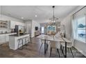 Open concept kitchen with island, stainless steel appliances, and dining area at 215 Briana Marie Way, Indian Trail, NC 28079