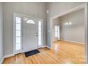 Home foyer featuring hardwood floors, a white front door, and an open view into dining room at 2288 S Paraham Rd, York, SC 29745