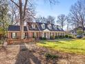 Brick home with a manicured lawn and lush landscaping, exuding charm and curb appeal at 2315 Red Fox Trl, Charlotte, NC 28211