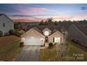 Lovely sunset aerial view of a well maintained home with beautiful landscaping at 2943 Village Center Dr, Dallas, NC 28034