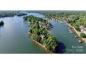 Expansive aerial view of an island community with waterfront homes and mature trees on a sunny day at 296 Windemere Isle Rd, Statesville, NC 28677