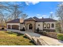 Gorgeous home featuring a stone entrance, arched doorway, and well-manicured lawn at 296 Windemere Isle Rd, Statesville, NC 28677