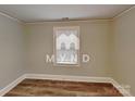 Simple bedroom with hardwood floors and a window at 3138 Morson St, Charlotte, NC 28208